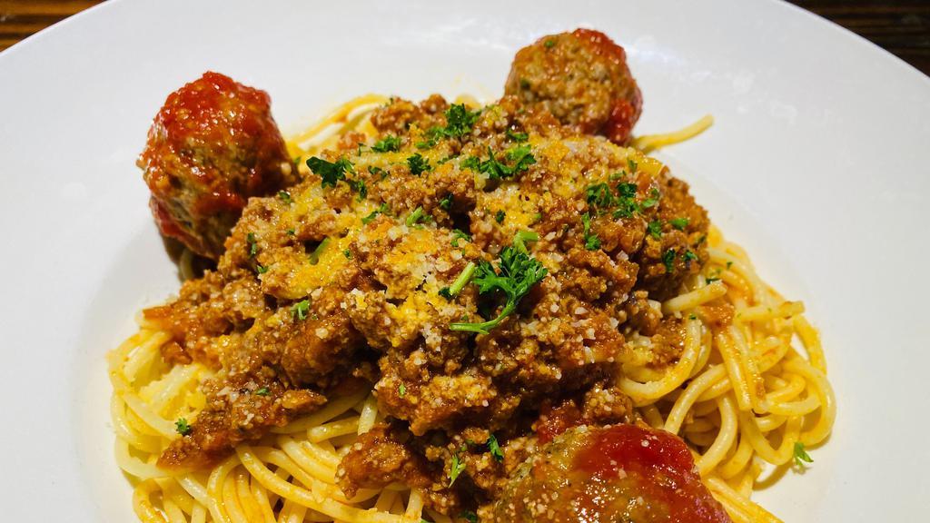 Spaghetti Bolognese · In our delicious meat sauce. Add meatballs or sausage for an additional charge. Your choice of soup or salad and garlic bread.