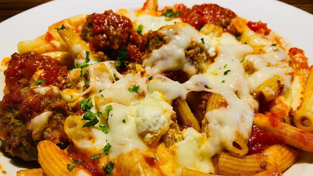 Maccheroni Al Forno · Mario's handmade maccheroni pasta, in a light meat sauce with meatballs, baked with mozzarella and ricotta. Your choice of soup or salad and garlic bread.