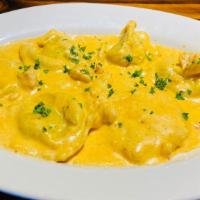 Seafood Ravioli · Mario's hand made crab and shrimp filled ravioli served in a delicious creamy lobster sauce ...