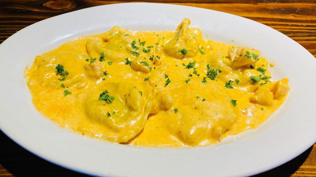 Seafood Ravioli · Mario's hand made crab and shrimp filled ravioli served in a delicious creamy lobster sauce topped with baby shrimp.your choice of soup or salad and garlic bread.