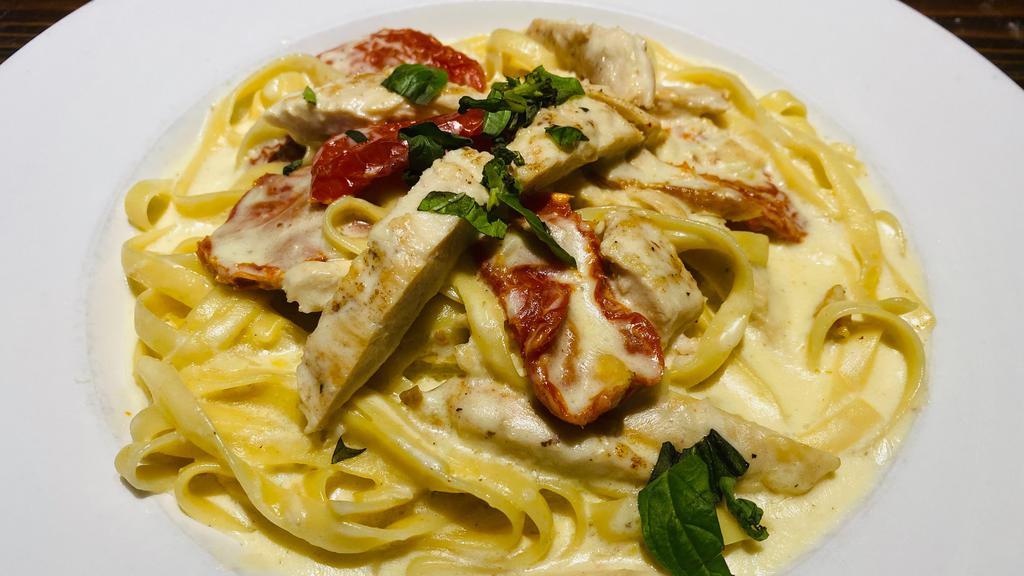 Fettucine Pomodori Secchi · House-made fettuccine tossed in garlic alfredo with grilled chicken, and sun-dried tomatoes. Your choice of soup or salad and garlic bread.