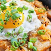 Kimchi Fried Rice (Kfr) · Fried rice mixed with kimchi, onions, pork belly, and topped with a sunny side up egg.