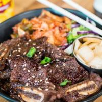 Kalbi Bowl · Korean short ribs over your choice of rice, kimchi, and lettuce mix.
