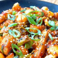 Korean Rice Cakes · Pan seared rice and fish cakes tossed in our house chili marinate and sautéed with cabbage, ...