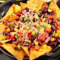 Macho Nachos · Delicious crispy nachos topped with melted cheese, ground beef, refried beans, green chili a...