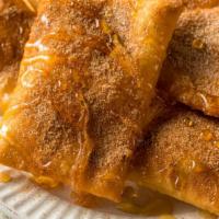 Sopapillas · Delicious puffy fried dough triangles topped with honey & cinnamon sugar, served with vanill...