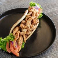 Chicken Shawarma Wrap · Marinated and grilled chicken shawarma served on a warm pita topped with our famous garlic s...