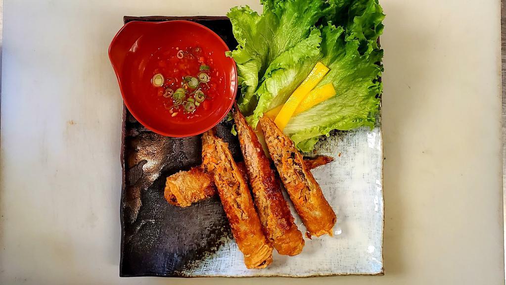 Traditional Vietnamese Eggrolls · Pork with taro, carrots, vermicelli noodles, mushrooms, and onions. Wrapped in egg-dough then fried to perfection. Served with lettuce, pickled daikon, and chili sauce.