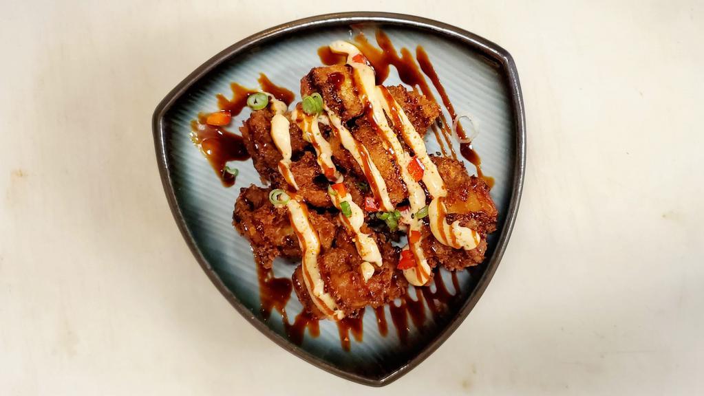Chicken Karaage · Japanese fried chicken drizzled with spicy mayo and teriyaki. Sprinkled with togarashi, green onions, and red peppers.