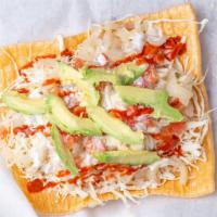 Chilindrina · One large duro topped with mayo, cabbage, avocado, cueritos(pork rind), pico, sour cream, an...