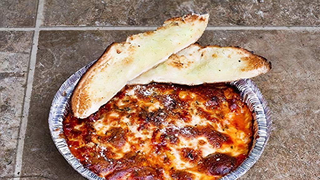 Mammas Lasagna · Meat lasagne covered with mead sauce topped with mozzarella baked. Includes piece of garlic bread.