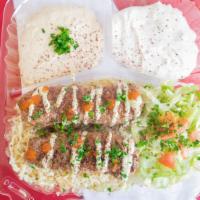 Kebab Plate · Beef kebabs rice salad hummus taziki garlic sauce hot sauce