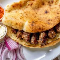 Cevapi · Skinless sausages made of minced beef, stuffed into fresh pita bread, served with onions.