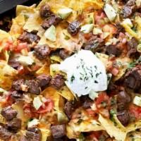 Birria Nachos · Cheesy delicious loaded nachos topped with Birria

Made with: Lettuce, onion, cilantro, toma...