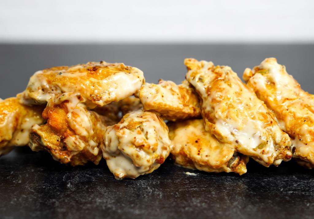 12 Classic Bone-In Wings · 12 Classic bone-in chicken wings tossed with wing sauce and served with ranch or blue cheese dressing