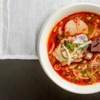 Bún Bò Hue · Spicy Beef Thick Rice Noodle Soup. Included Pork Hock, Brisket, Fried Pork Loaf & Tendon. Op...