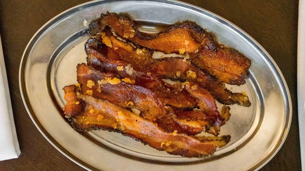 Crack Bacon (5) · five pieces of our house crack bacon made with brown sugar and black pepper.