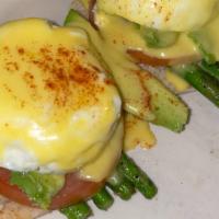 The California · avocado, grilled asparagus, and grilled tomato slices, topped with two poached eggs and holl...