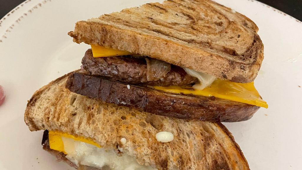 Patty Melt · Angus beef patty, American and Swiss cheese, caramelized onions, garlic aioli, on grilled marble rye