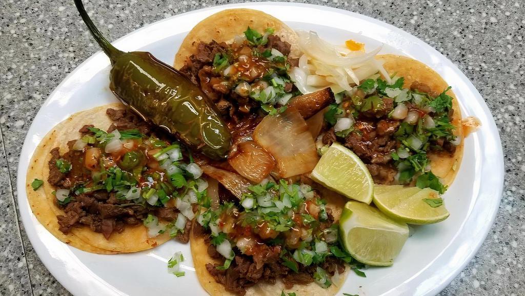 3 Tacos Of Birria (Street Tacos) Rice & Beans · 3  Street Tacos of beef (birria style)
onion & cilantro, limes, red & green sauce.
rice & beans.