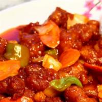 Sweet & Sour Chicken · Deep-fried chicken sautéed in sweet & sour sauce with onions, green peppers &carrots.