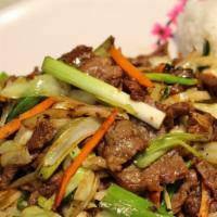 Mongolian Beef · Marinated slices of tenderized beef stir-fried with onions and green onions.