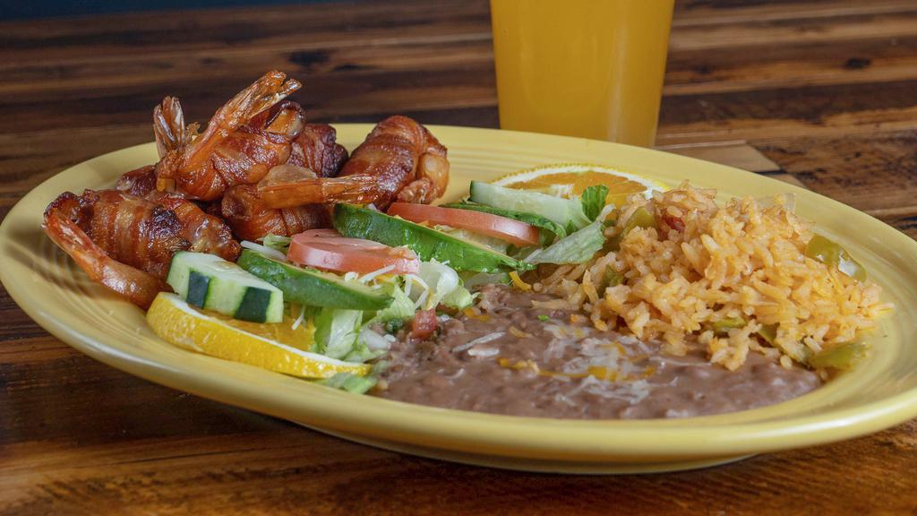 Camarones Rellenos · Shrimp stuffed with cheese and wrapped in bacon.  Served with rice, beans, tortillas and a light salad.