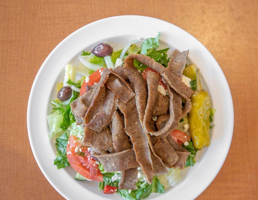 Gyros Salad · Gyros meat on a mix of green leaf and romaine lettuce, tomatoes, onions, cucumbers, bell peppers, feta cheese,  olives with homemade greek dressing and tzatziki sauce.