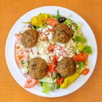 Falafel Salad · Falafel served on top a mix of green leaf and romaine lettuce, tomatoes, onions, cucumbers, ...