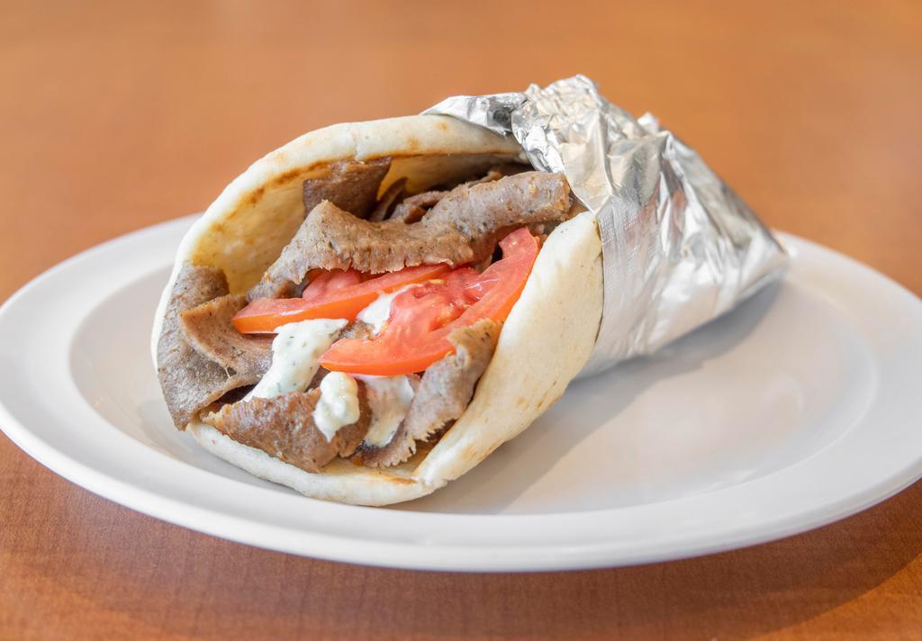 Gyros Pita · Chicago style gyros broiled on vertical skewer served with onions, tomatoes, and tzatziki sauce on pita bread.