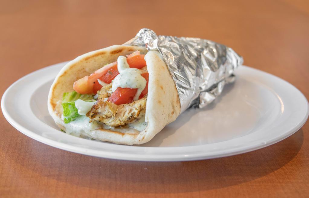 Chicken Pita · Greek style marinated chicken breast served with lettuce, onions, tomatoes and tzatziki sauce on a pita bread.