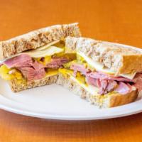 Pastrami On Rye · Gilled pastrami served with mustard and pickles with swiss cheese.