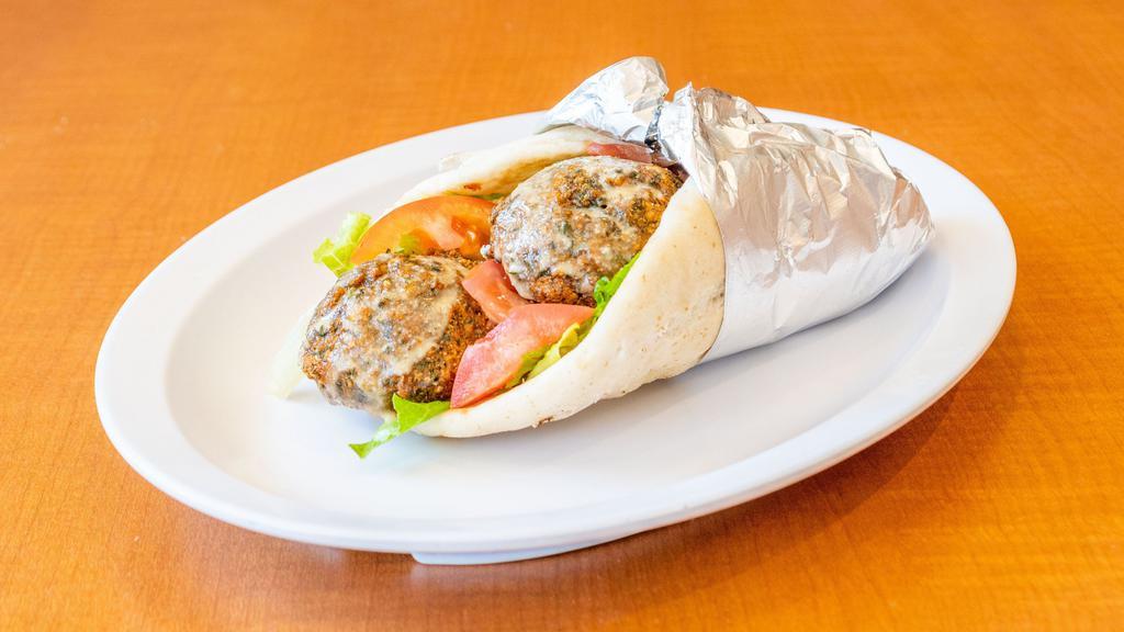 Falafel Pita · Vegetarian. Mix of chickpeas, onions, garlic, parsley, served with lettuce, tomatoes and tahini sauce on a pita bread.
