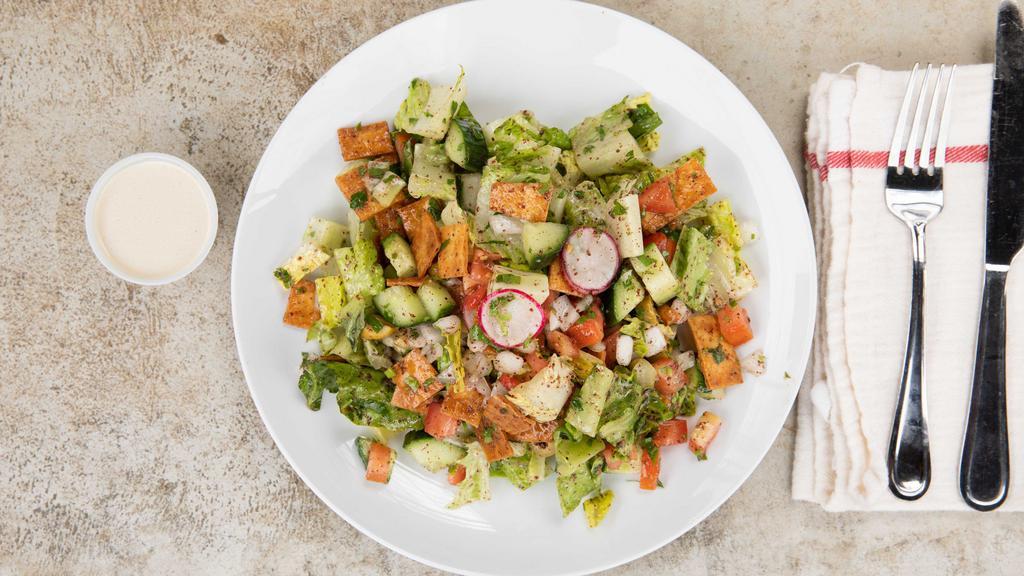 Peasant Bread Salad (Fattoush) · Vegan. Romaine lettuce, tomatoes, cucumbers, onions, olives, parsley, pickles, radishes, mint, bread crumbs, and sumac dressing.