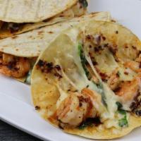 Taco Enchilado · Tacos de camaron picoso, con queso, cebolla, cilantro, crema y chile. 
Spicy shrimp tacos wi...