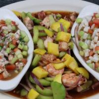 Botana Sinaloa · Ceviche de Camaron, Ceviche de Pescado, Camaron Cocido y Pulpo.
Appetizer with a tostada of ...