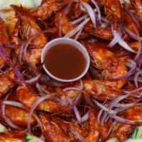 Camarones Cucarachos · Camaron entero frito en salsa chipotle. 
Head on fried shrimp in chipotle sauce.