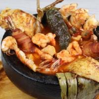 Molcajete Marisquero · shrimp, fish fillet, abalone, bacon wrapped shrimp and red hot sauce.