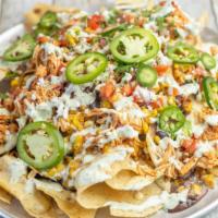 Street Corn Nachos · grilled chicken + queso sauce + creamy mexican street corn + black beans + roasted jalapenos...