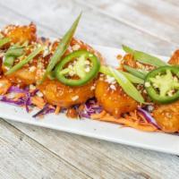 Firecracker Shrimp · beer battered shrimp tossed in our house firecracker sauce + crushed pepitas + cotija cheese...
