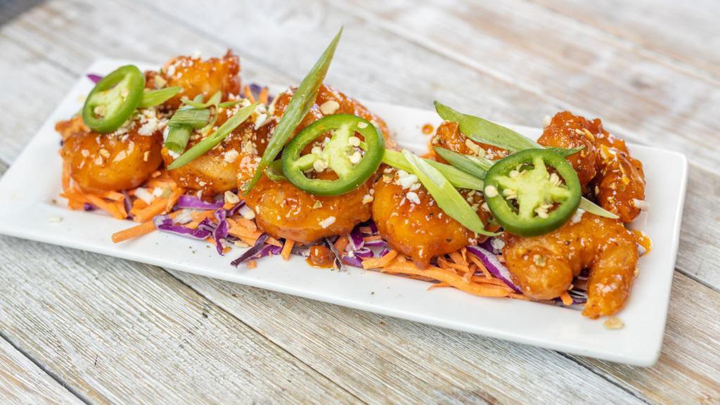 Firecracker Shrimp · beer battered shrimp tossed in our house firecracker sauce + crushed pepitas + cotija cheese + green onions + jalapenos