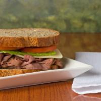 Emerald City Rancher · Seasoned roast beef,  Cheddar, lettuce, tomato, onion, horseradish sauce. Sandwich comes on ...