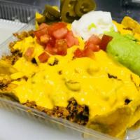Nachos · Chips, meat option, nacho cheese, beans, sour cream, guacamole, tomatoes, jalapenos