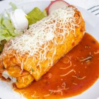 Wet Burrito · Choice of meat, rice and beans inside, enchilada sauce and cheese on top, lettuce, sour crea...