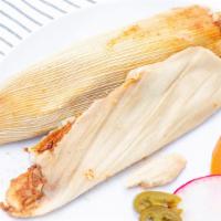 Tamales · Two tamales, comes with rice and beans on the side, enchilada sauce and cheese on the top