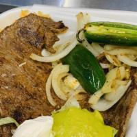 Carne Asada (Grilled Steak) · Two pieces of steak (flat meat) rice and beans, lettuce, sour cream, guacamole, and flour or...