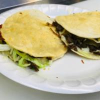 Mulitas · Corn tortilla on top and bottom melted cheese choice of meat and lettuce
