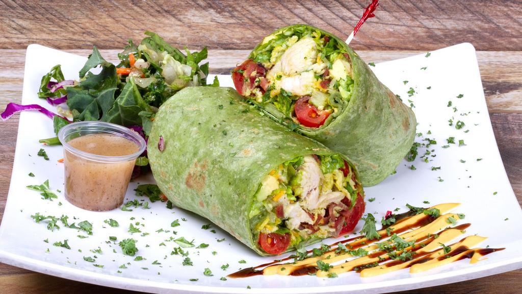 Cali Cobb Wrap · All Natural Chicken Breast, Hard Egg, Turkey Bacon, Avocado, Cherry Tomatoes, Cheddar Cheese, Shredded Romaine Lettuce, Balsamic Glaze and House Made Dijon Balsamic. 
(670cal 43protein 54carb 33fat) 
Contains Dairy