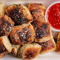 Garlic Nugs · Pizza dough nuggets baked and tossed in garlic, herbs and parm with pizza sauce and scallion...