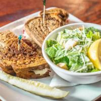 Double Play Reuben · Slow braised corned beef topped with sauerkraut and Swiss cheese on toasted marble rye, with...
